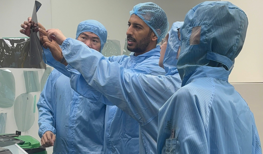 GenusCars Founder discussing professional Window Tinting installation process and checking products quality in the factory